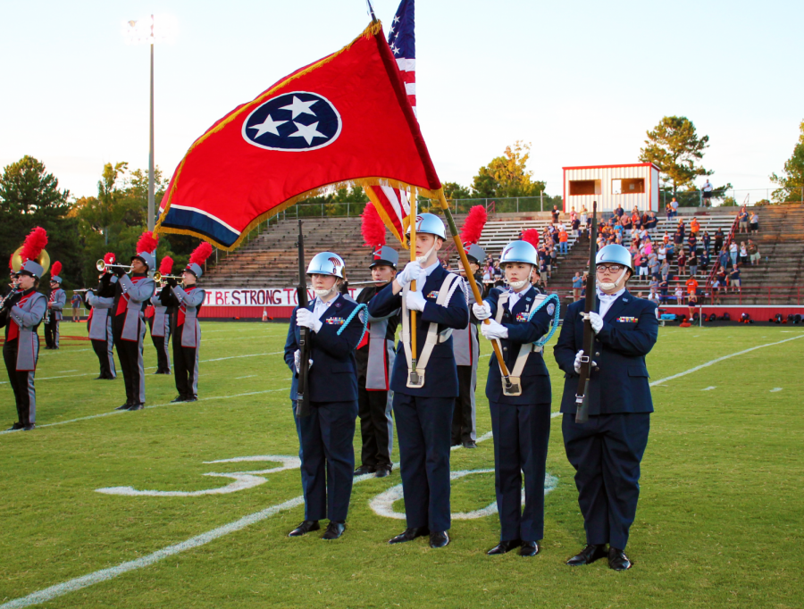 Left to right cadets Madison Cox, Oren Harper, Kinsey York, and Tabby Syferd presenting the colors at a football game