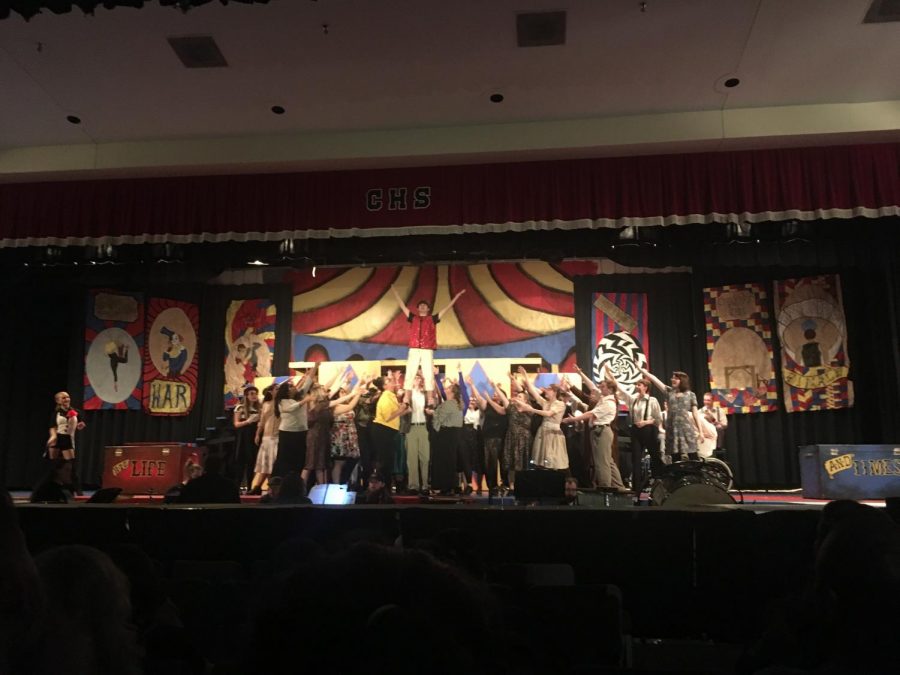 The cast of Pippin sing as they support Alex Baldwin