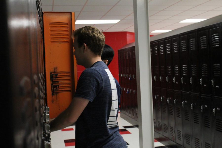 Students Austin Farris, and Ferdinand Ngo  at their lockers 