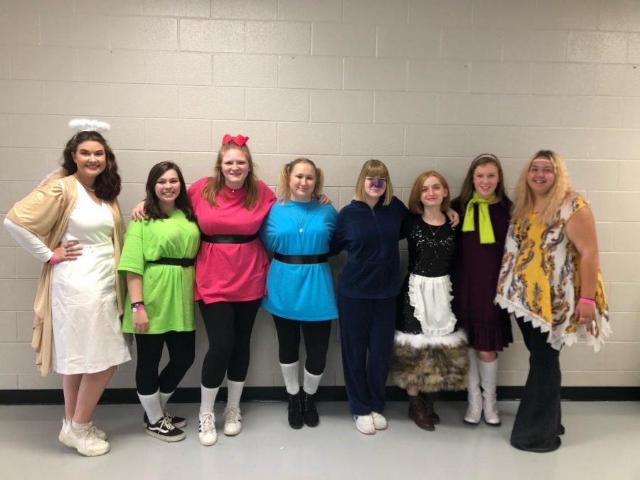 The Hive members from left to right, Emma Holmes, Madylyn Holder, Mariah Black, Hanna Brock, Madison Hershman, Sarah Thomas, Kailee Shores and Liberty McAfee, pose on Halloween in their costumes. 