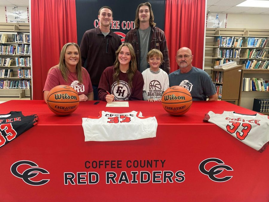 Elli Chumley signed with her family members alongside her.