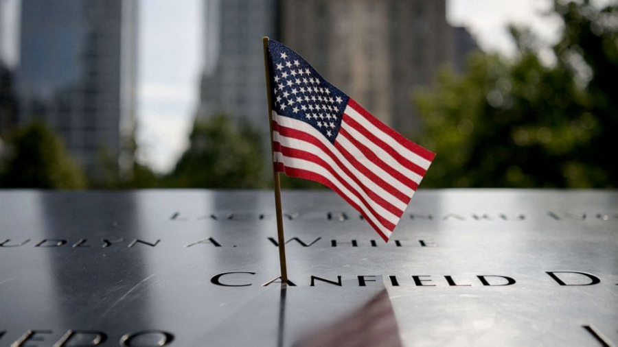 A miniature American flag waves proudly in the breeze beside the 9/11 Memorial Pools, representing the sacrifices of thousands of individuals 21 years ago on Sept. 11, 2001.