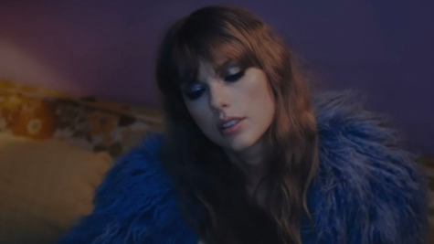 The one and only Taylor Swift stuns in a purple feathered coat in the music video for “Lavender Haze.”
