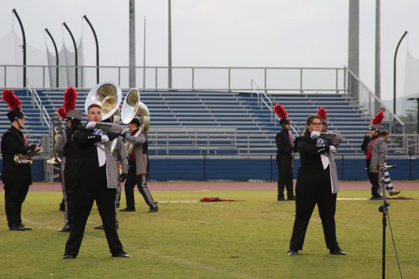 Drum Majors Owen Baskin and Aubrey Crosslin salute the crown, showing the judges that the band is ready to take the field in competition.